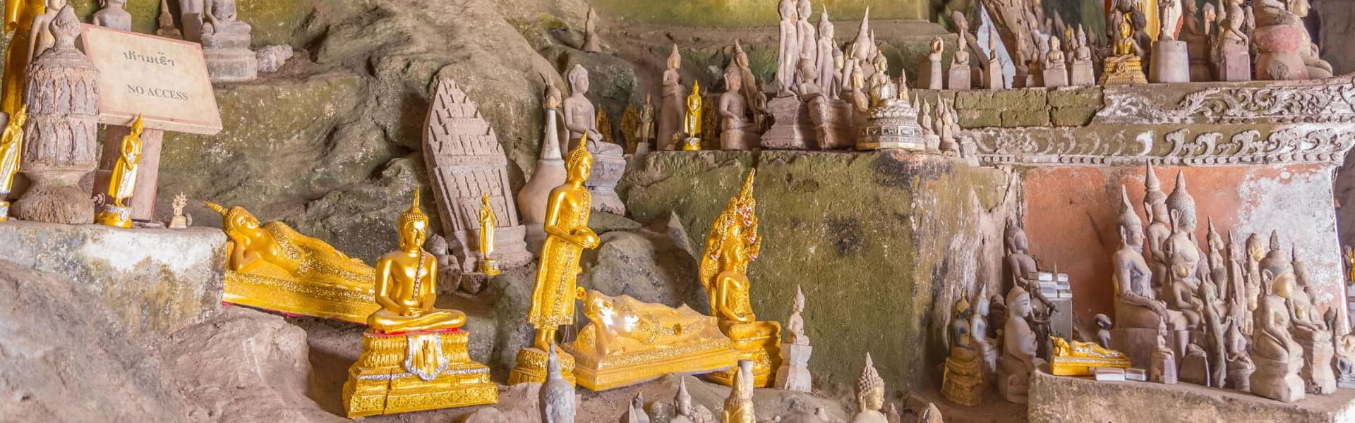 Sacred Pak Ou Caves along the Mekong in Laos on a scenic Pak Ou Travel banner by Legend Travel Group.